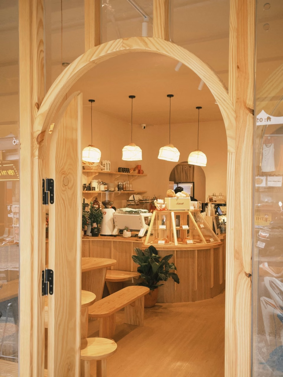从木门望进 La Lapine Tăng Bạt Hổ 分店,里面有藤编灯笼和糕点柜